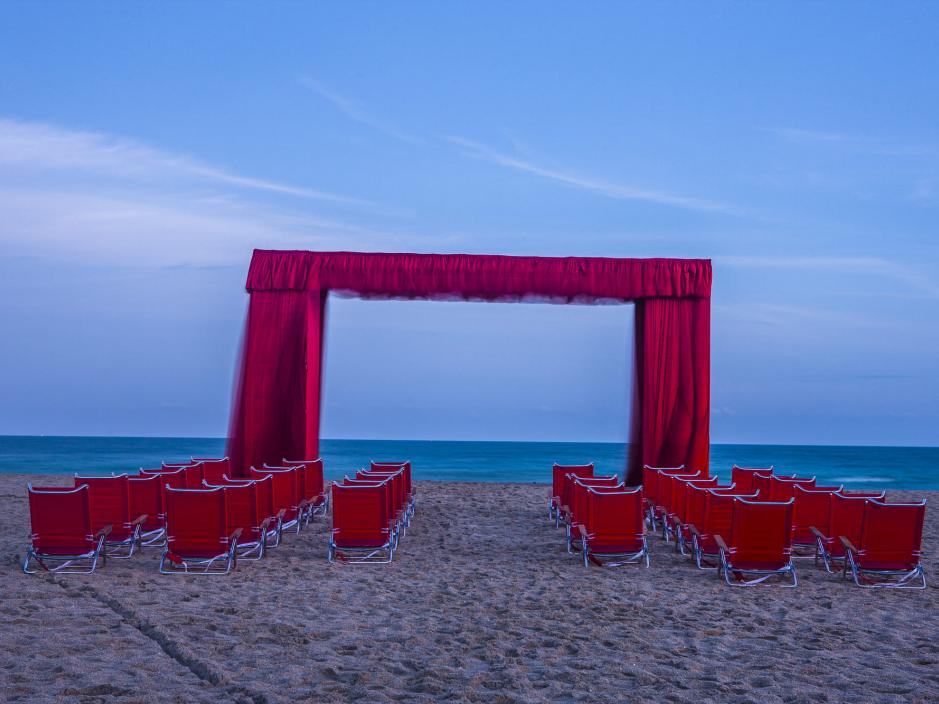 Stage curtain on the beach with beach chairs for people to view the ocean