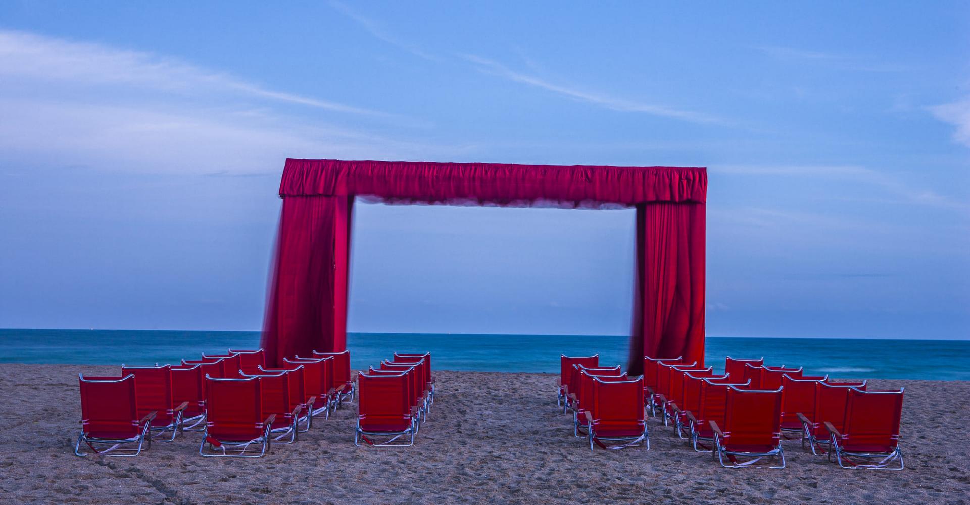 Stage curtain on the beach with beach chairs for people to view the ocean